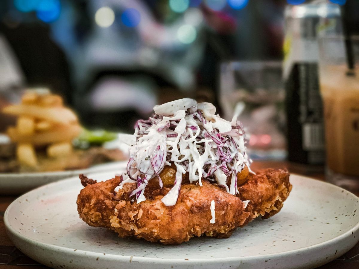 Fried chicken, topped with slaw
